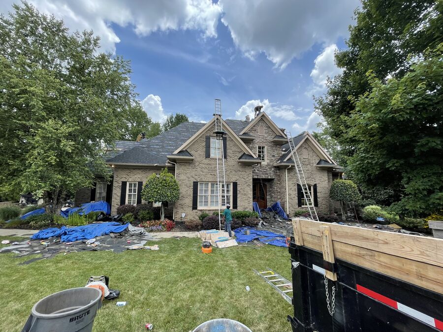 Acme Roofing crew working on a roof tear-off and replacement